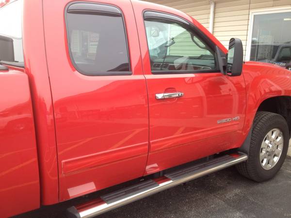 2011 GMC Sierra Extended Cab with Putco Chrome Door Handles, Westin 6" SST Oval Running Boards, and AVS Smoke In Channel Rain Guards