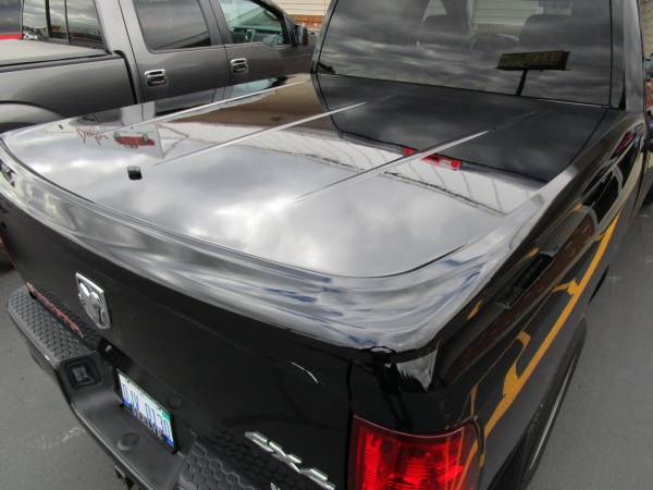 The 2015 Dodge RAM with a painted to match UnderCover SE Hard Tonneau!