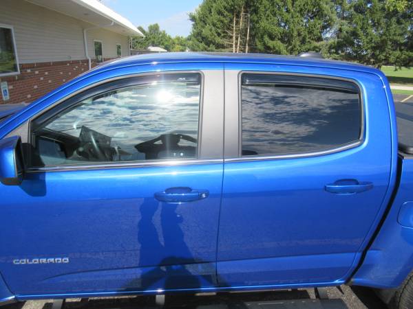 Chevy Colorado With New Runnding Boards, SolidFold Bed Cover, and AVS Winddefelctors.